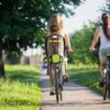 Two girlfriends riding bicycles