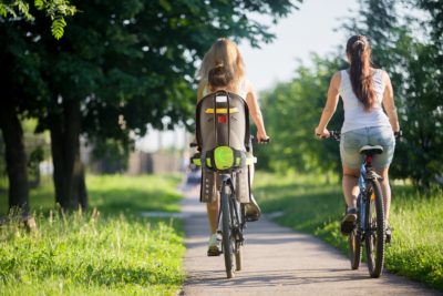 Two girlfriends riding bicycles